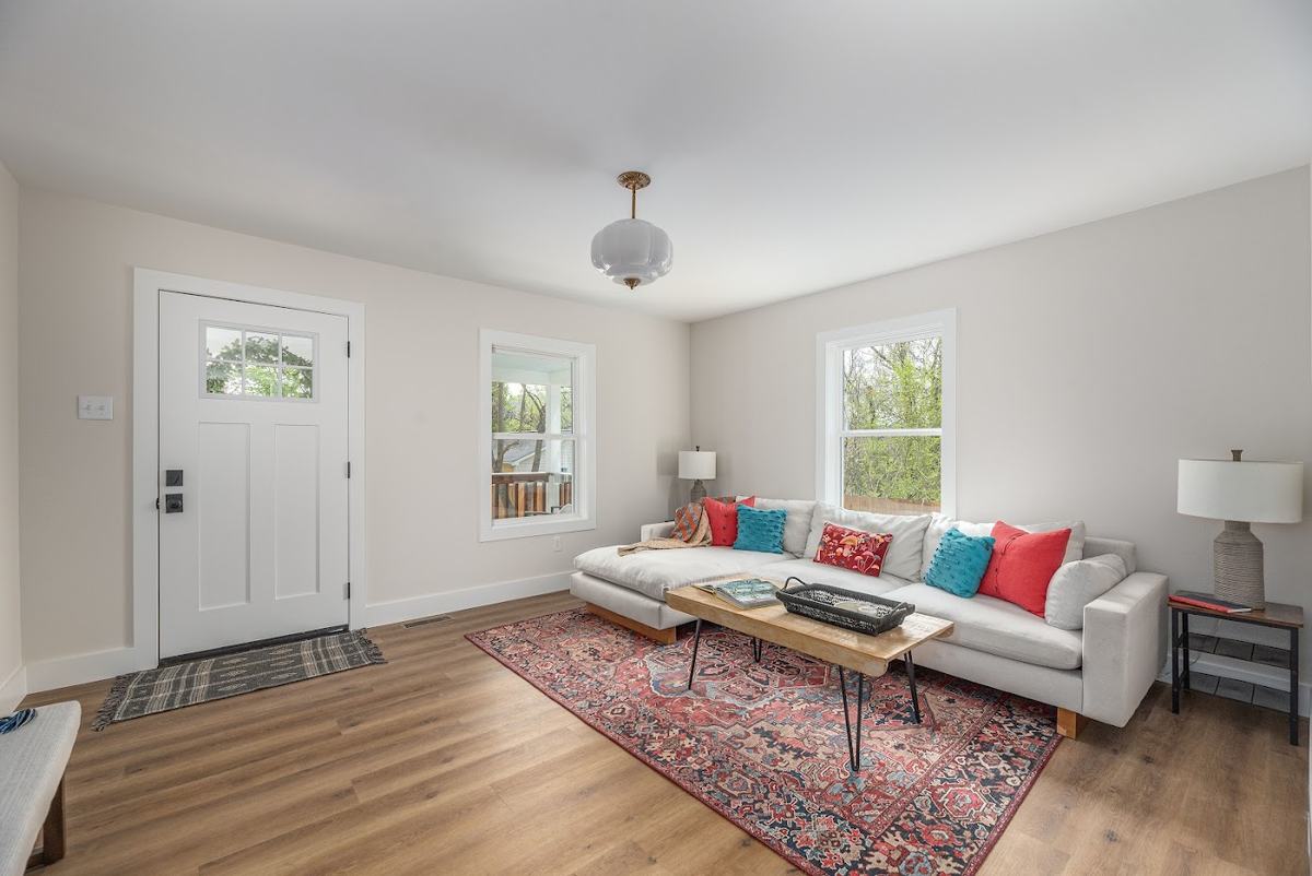 Living room with front door, sofa and rug