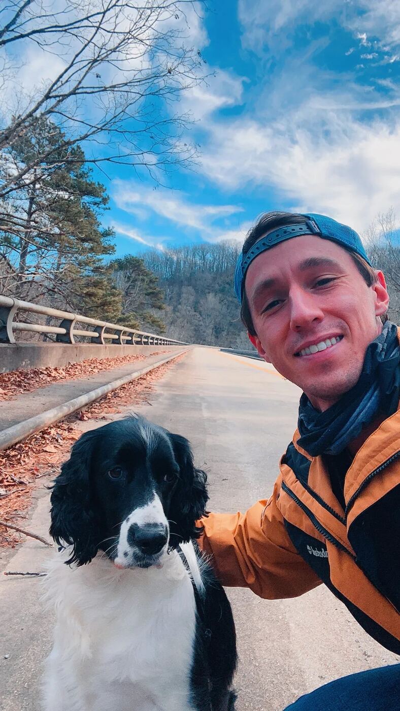 Dylan Lennon and his dog Wesley on a mountain road near Asheville